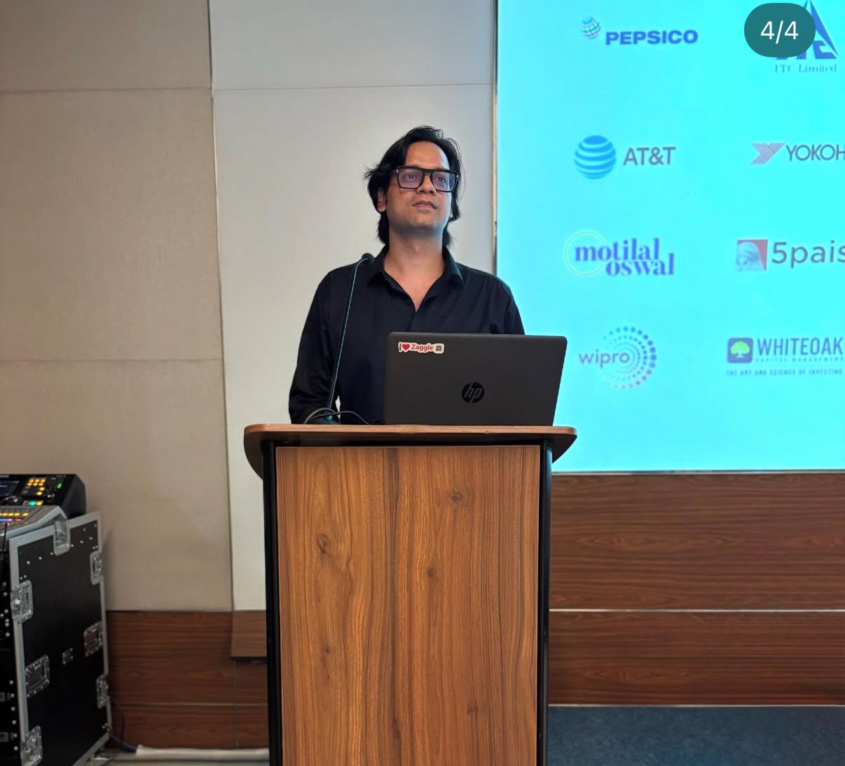 Shivendra delivering a keynote from a podium